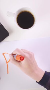 Person write PLAN on piece of paper at the office