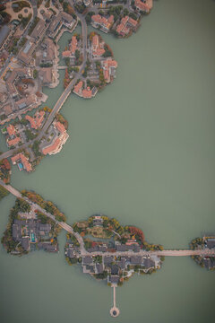 Aerial view of Li Gong Di Feng Shang Pedestrian Street Qu with traditional architecture and bridges over the calm water of Jinji Lake in Suzhou, Jiangsu, China.