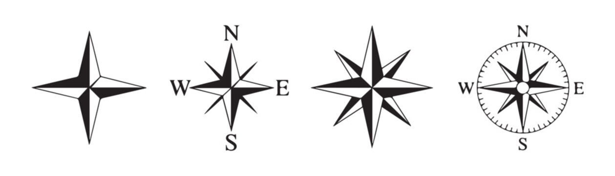Set of four distinct compass rose and navigation stars for map design isolated on grid transparency.