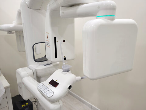 Dental x-ray scanner in a clinic. Modern panoramic radiograph machine for teeth examination. Innovative medical technology for oral diagnostics, healthcare and dental treatment.