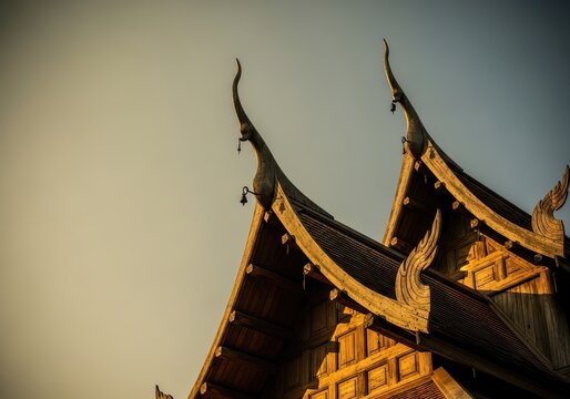 Traditional Thai Temple Roof with Intricate Wood Carvings and Hanging