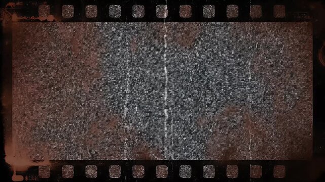 A vintage film strip with perforations and scratches displays a grainy, monochrome texture, evoking a sense of nostalgia and cinematic history.