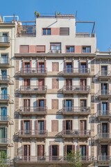 Fototapeta premium Barcelona Building Facade with Traditional Sgraffito Ornaments and Brown Shutters, Penthouse Terrace