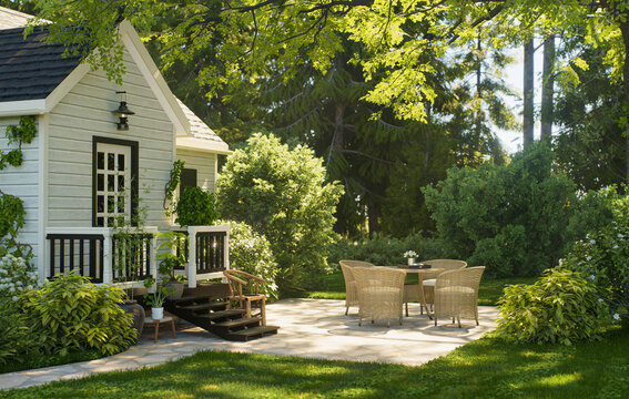 Charming garden cottage with patio seating in a lush sunlit backyard