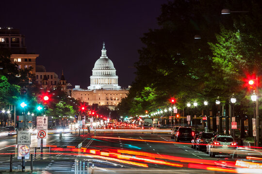 Evening street view of the US Capitol building along Pennsylvania