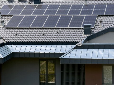 Aerial view of solar panels installed on a modern tiled roof with metal roofing details in Istanbul, Istanbul, Turkiye.