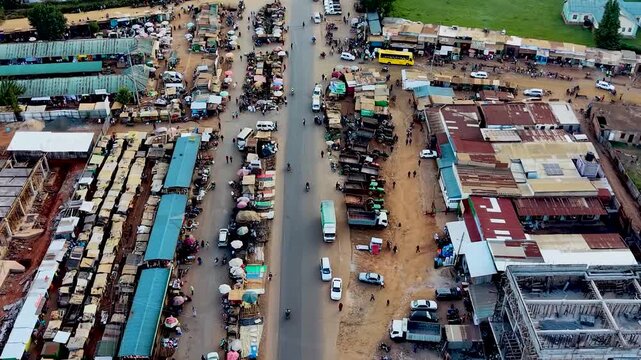 Rural kenya village market Africa poverty poor road infrastructure cars moving on the poor maintained roads in kenya