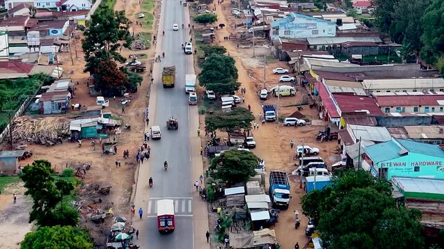 Rural kenya village market Africa poverty poor road infrastructure cars moving on the poor maintained roads in kenya