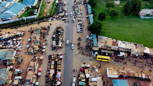 Rural kenya village market Africa poverty poor road infrastructure cars moving on the poor maintained roads in kenya