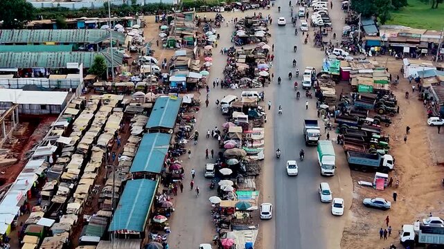 Rural kenya village market Africa poverty poor road infrastructure cars moving on the poor maintained roads in kenya