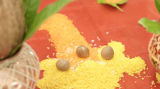 Traditional Hindu ritual setup featuring vibrant colored Akshata and sacred betel nuts, symbolizing blessings, prosperity, and devotion during auspicious religious ceremonies.