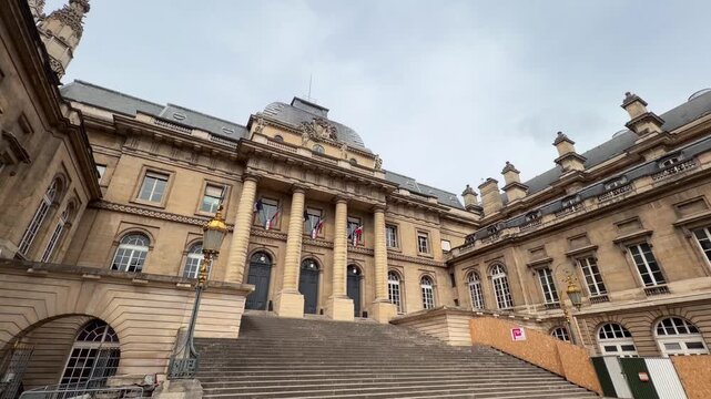 Low-angle view of the impressive classical facade of the Palace of Justice, also known as the Palais de Justice, a famous historic landmark located on the &Icirc;le de la Cit&eacute; in central Paris