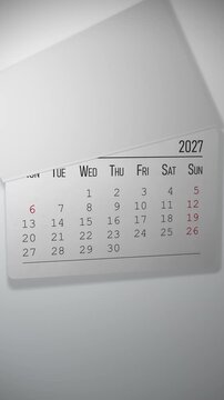 Animated 2027 wall calendar with pages tearing away to reveal April in soft studio light, vertical motion graphic about passing time and deadlines for social media