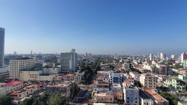 Aerial view of Vedado district with dense urban architecture, historic and modern buildings under a clear blue sky in Havana, Havana, Cuba.