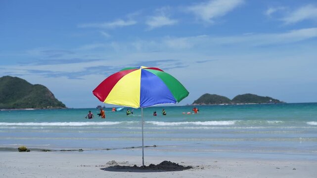 Beach sea umbrella sand sky island vacation travel, colorful parasol and sunshade on quiet shoreline, turquoise water with swimmer, gentle wave, tropical summer seascape for relaxation