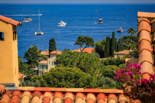 Aerial view of luxury villas on Saint Jean Cap Ferrat peninsula on the French Riviera, South of France, with boats on the Mediterranean Sea