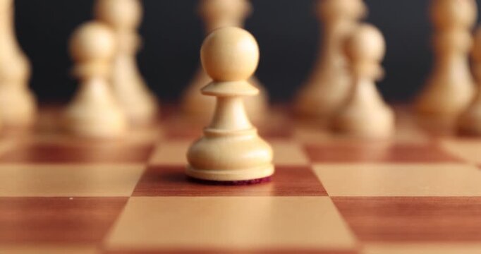 Playing chess. Man making first move with pawn, closeup. Camera moving backwards
