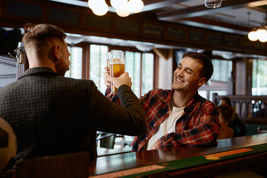 Two caucasian men share relaxed moments and cheerful conversations at friendly pub
