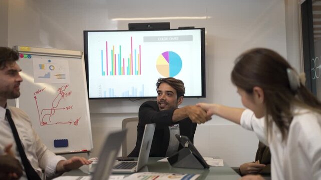 Business Team Handshake and High Five Across Meeting Table