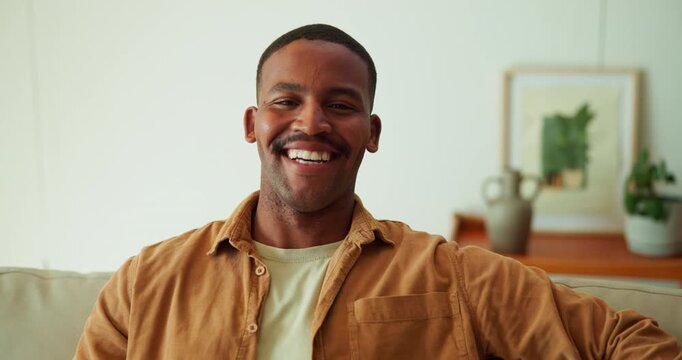 Face, laugh and black man in living room with humor, positive attitude and relax on weekend break. Happy, African person and chill in home with optimism, funny thought and stress free for wellness.