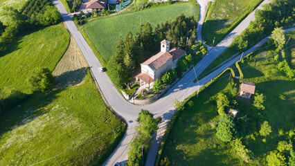 Fototapeta premium Aerial View of a Rural Church and Winding Roads in Piedmont