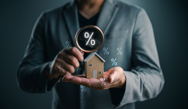 Mortgage interest rate concept with a wooden house under a magnifying glass, symbolizing home loans, refinancing, property investment, housing finance, banking decisions, real estate market analysis.