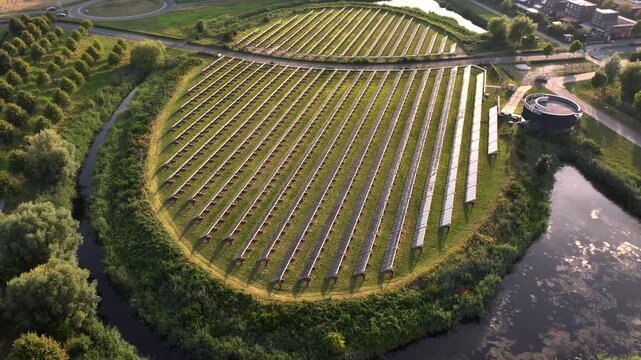 Solar panel island (Zoneiland) with reflections of sunlight on the solar panels. Aerial Shot in Almere, the Netherlands