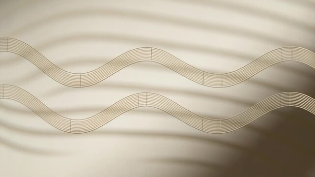 Moving two golden wavy ribbons sliding left over beige gradient, with sliding shadow bands on start