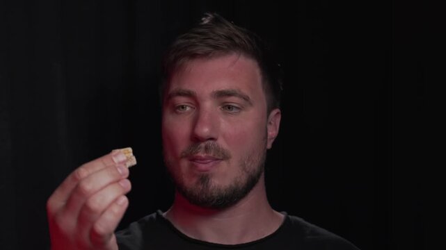 A handsome young man demonstrates marmalade sweets, Turkish delight, and begins to eat even more appetizingly.