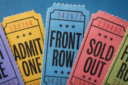 Close-Up of Colorful Vintage Ticket Stubs Reading Admit One, Front Row and Sold Out &mdash; Retro Event and Entertainment Concept