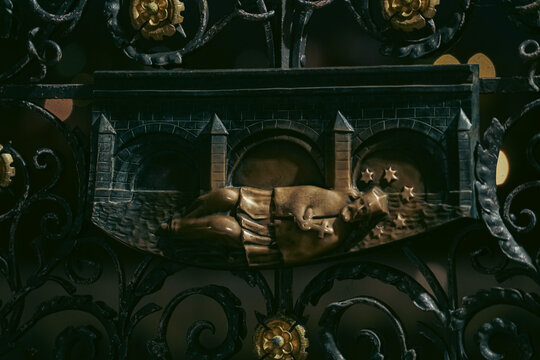 Prague, Prague, Czechia - 03 November 2021: View of the bronze relief of St. John of Nepomuk on the historic Charles Bridge, featuring intricate ironwork details.