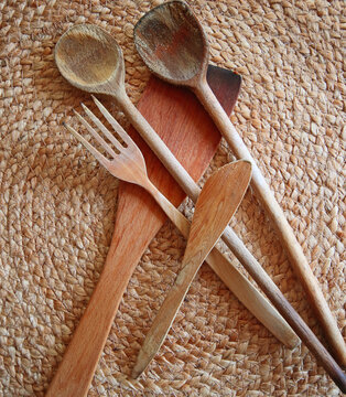 Kitchenware: used wooden spoons and spatulas to stir and fry food  on natural background