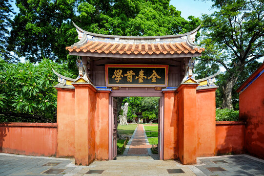 Traditional red gate of an ancient confucian temple with swallowtail roof in Tainan, Taiwan