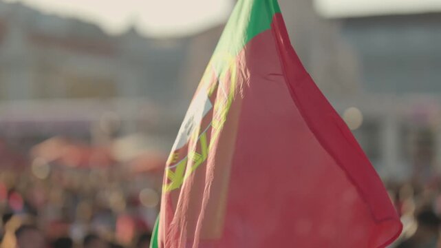 Crowd gathers in the city to celebrate national pride with flags and music in the evening sun