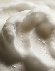 Fototapeta premium Soft white foam bubbles macro texture for skincare and cleansing background
