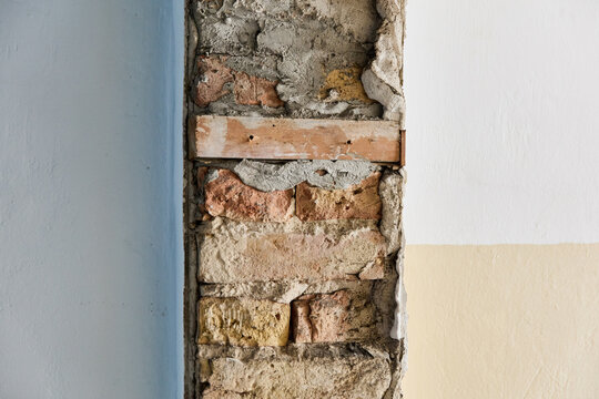 Historic Building Renovation: Exposed Brick Wall And Plaster Detail In Wilhelminian Era Apartment During Demolition Phase