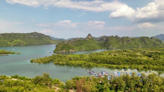 Cinematic 4K drone footage sweeping over the breathtaking landscape surrounding Tanjung Rhu Beach, revealing dramatic coastline and vivid turquoise waters in Langkawi, Malaysia.