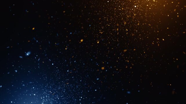 Floating particles drift in deep blue and warm orange hues. Light glows from above, casting soft, golden reflections. Dust motes swirl gently, creating a sense of quiet motion. Perfect for backgrounds