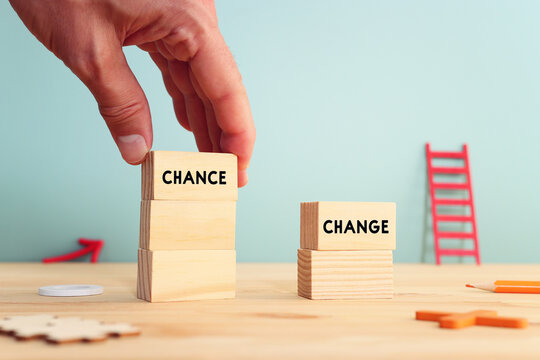 Wooden cubes with the words change and chance on wooden table