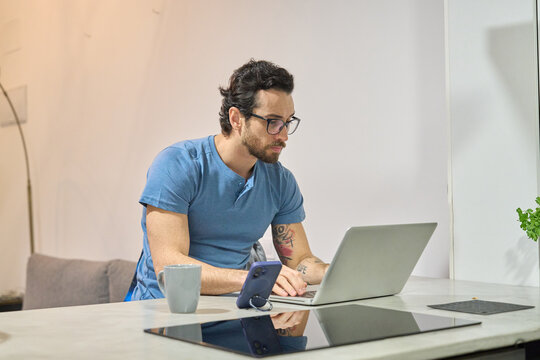 Man working remotely on laptop at home