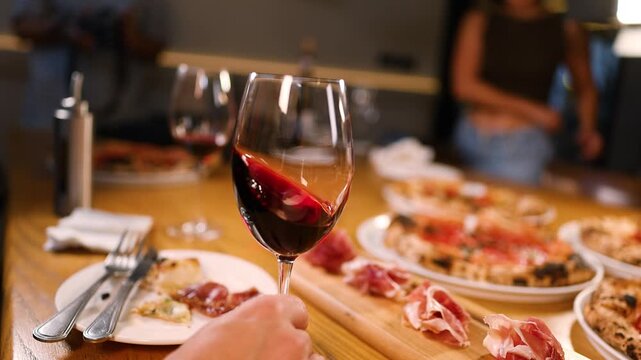 Close Up of Red Wine Swirling in Glass at Italian Dinner