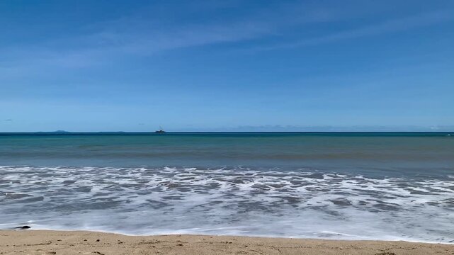 Ultra HD 4K morning view of gentle waves at Tanjung Lesung Beach, Banten, Indonesia. Suitable for travel, tourism, summer, relaxation, nature, and coastal background themes.