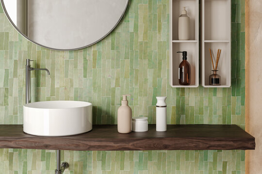 Modern bathroom vanity detail with round mirror, white countertop basin and green zellige tiles
