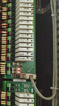 Consistent green LEDs arranged on clean white display panels create calm environment. Uniform green indicator lights across orderly white units suggest stable and reliable system performance
