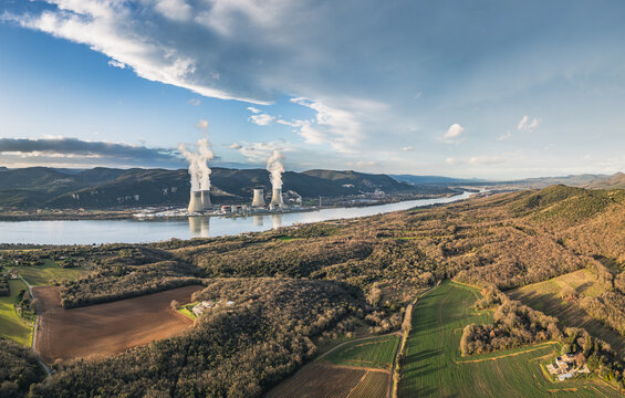 Cruas, France - 12 February 2026: Aerial view of the Cruas Nuclear Power Plant situated along the Rhone River, surrounded by rolling hills, agricultural fields, and forests.