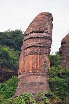 Rock formations in Danxia Mountains (Danxiashan) in Renhua County in Shaoguan (Guangdong Province) in China. Yang Yuan Stone (Yangyuan) also known as Male Stone, known for its phallic shape.
