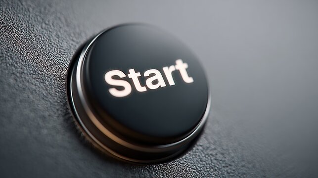 Close up of a dark start button with glowing text on a textured background