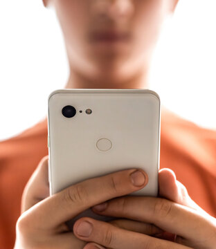 Child, teenager or preteen mobile phone. Child boy with cell phone, holds smartphone. Problem of children's addiction to gadgets, online, screen time