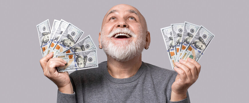 Cash, currency, wealth, finance, prosperity. Rich old grandfather businessman freelancer working money dollar cash. Senior man holding dollar banknotes, showing