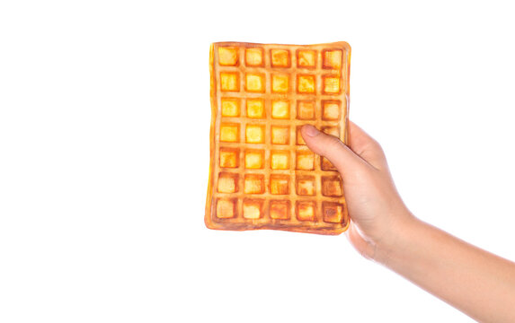 Belgian waffles in hand. Man holding a holiday cookie. Fresh baking concept. Sweet desserts. Hand holding waffle. Holding waffles